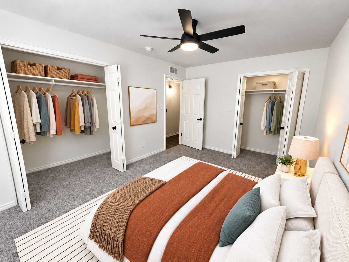 Bedroom with two large closets organized with hanging clothes and storage baskets