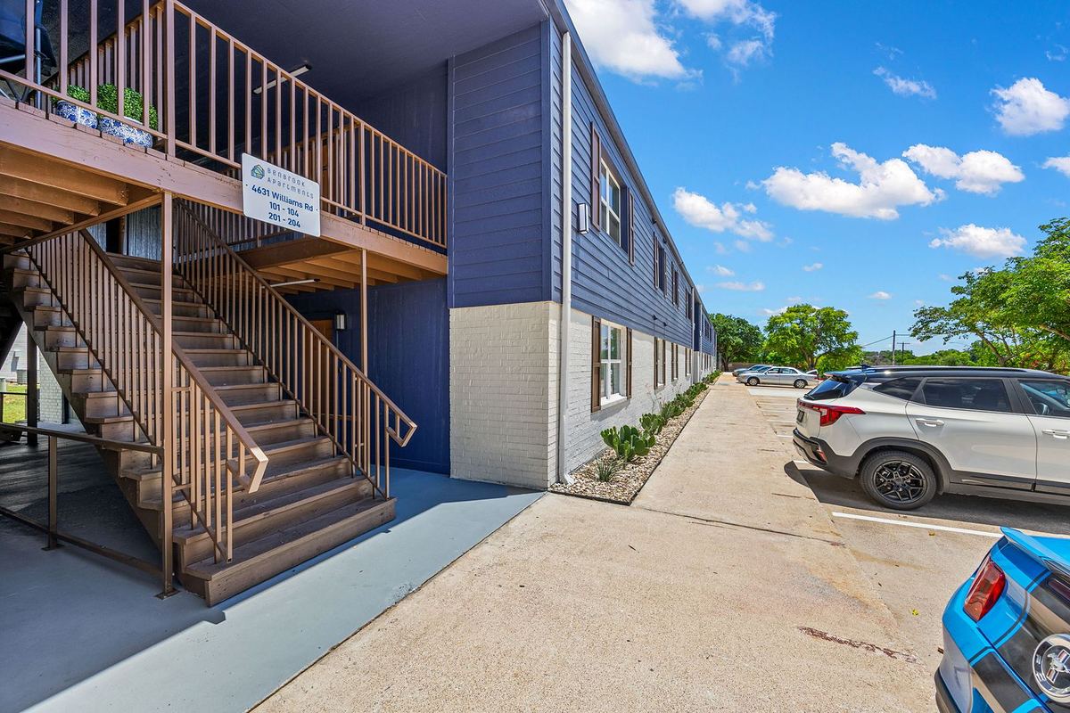 Covered stairwell and landscaped walkway along the building